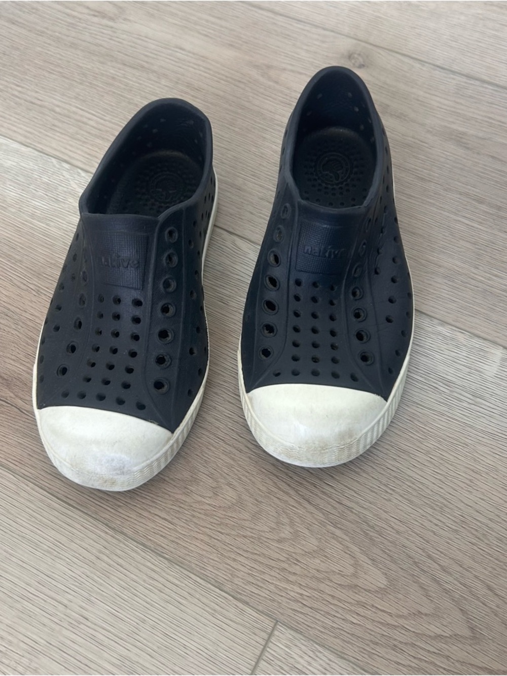 Size 10. NATIVES. Black Slip-On Rubber Sneakers with White Toe Caps